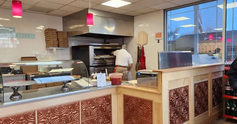 Mike Perrucci at the oven making fresh pizza